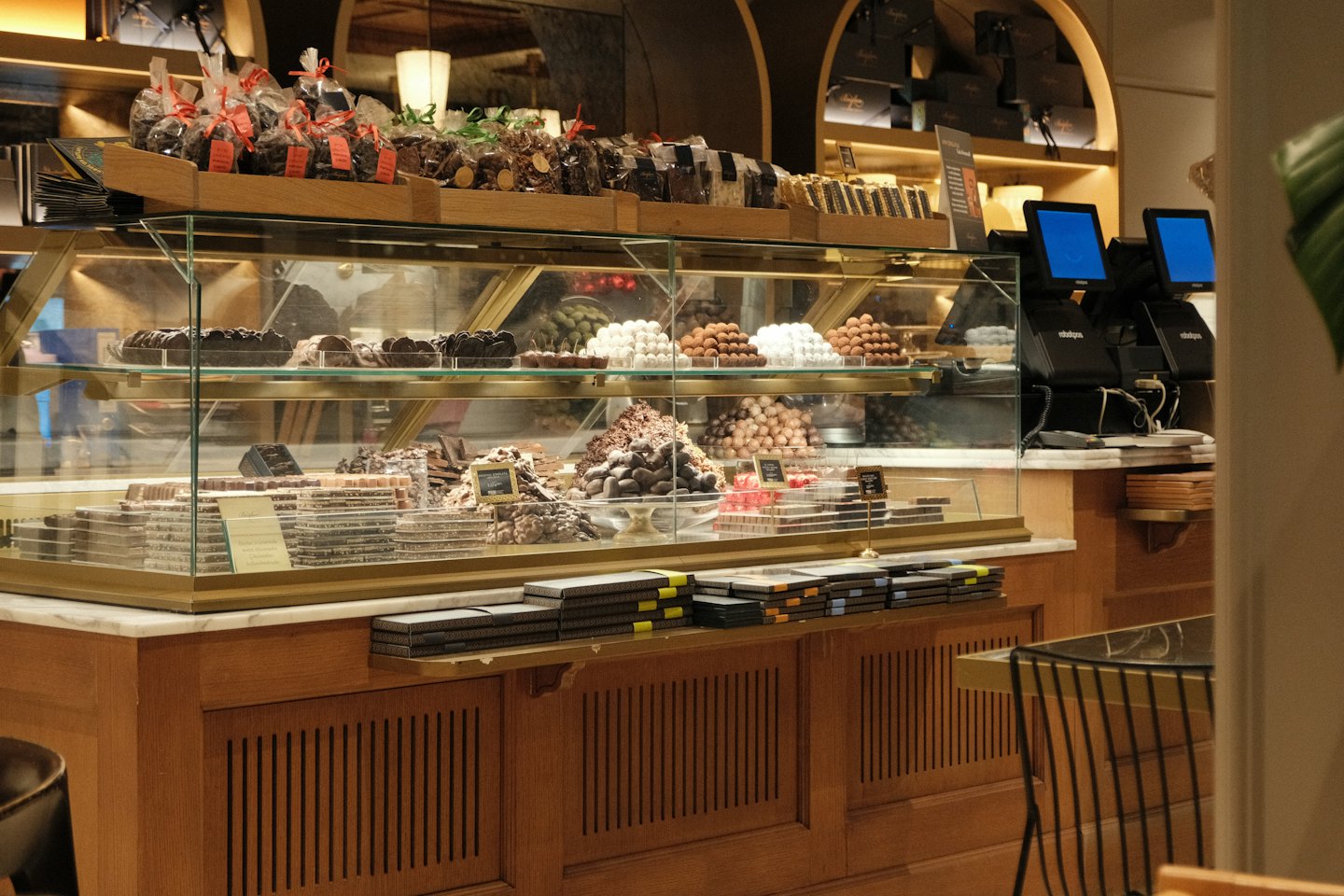 Artisanal chocolates and truffles displayed in a luxury shop counter.
