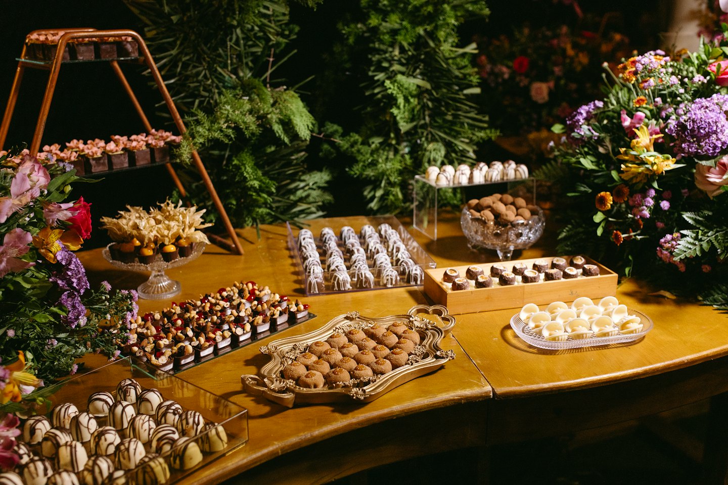 Artisan chocolates and confections displayed on a wooden table.